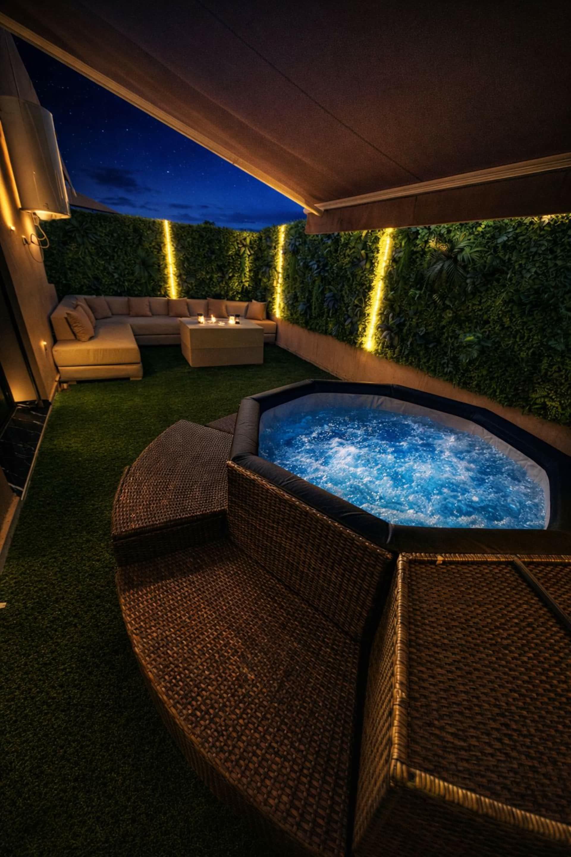 Studio Garden's jacuzzi at dusk, outdoor lounge in the background