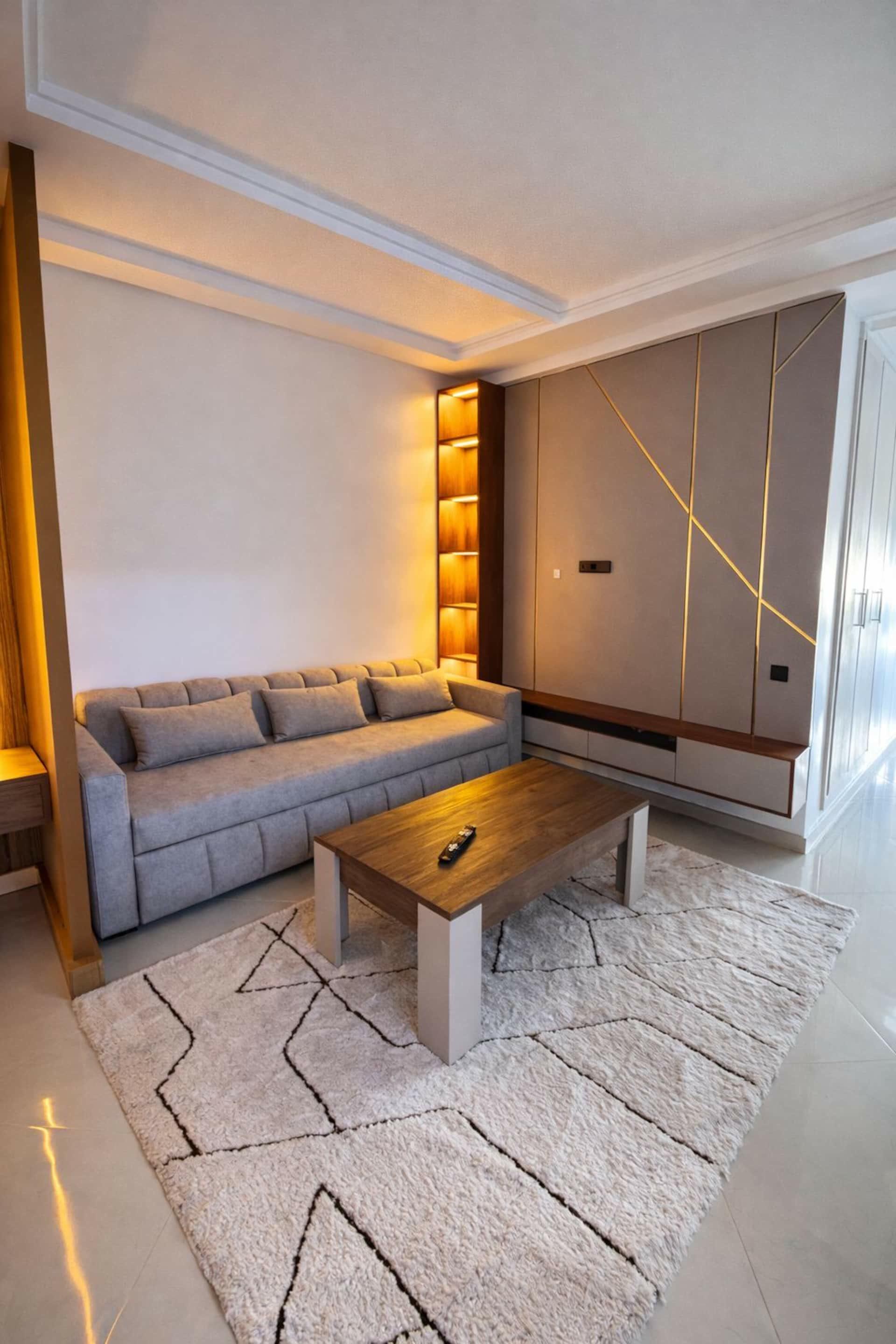Living room with golden lines, sofa and wooden coffee table