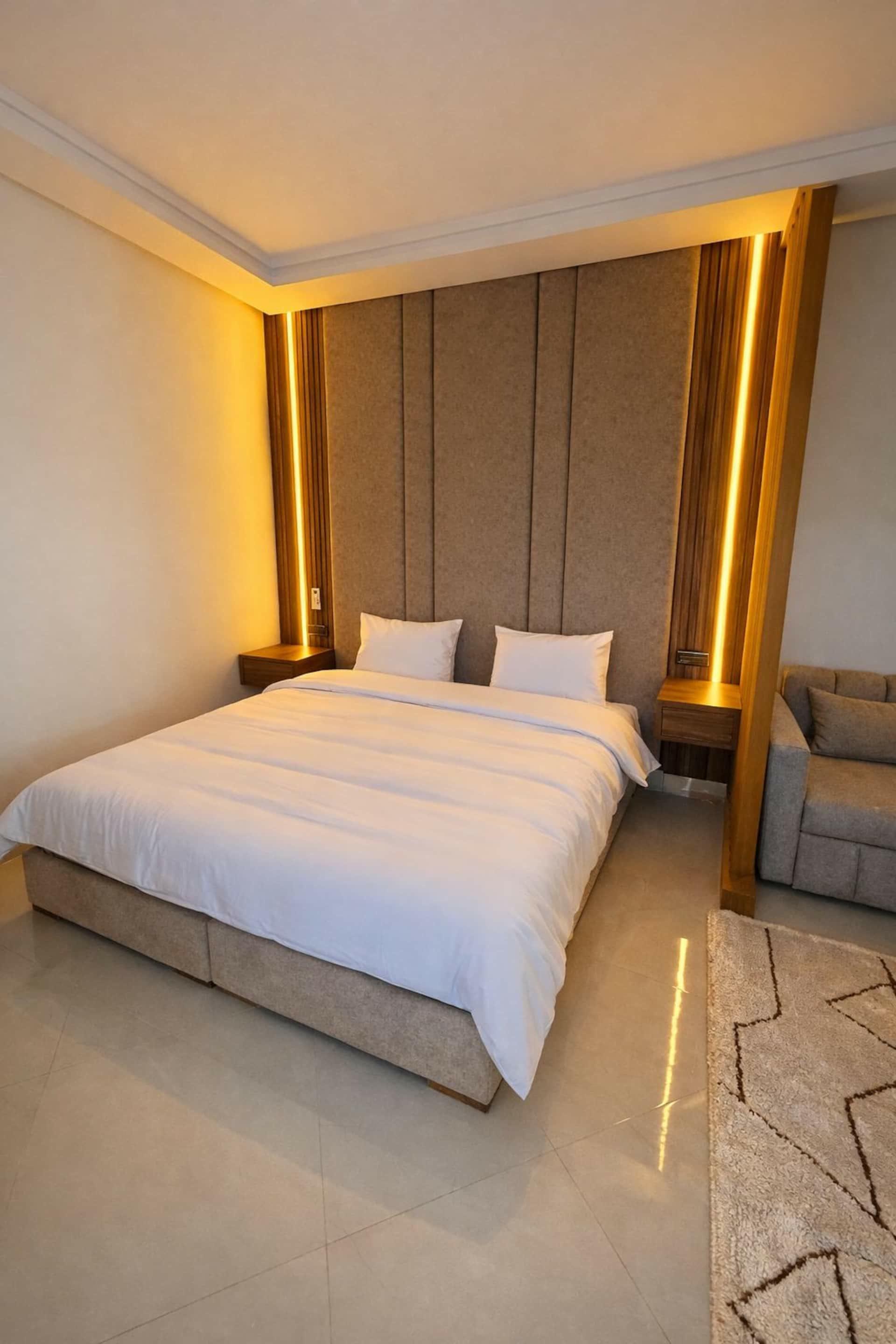 King-size bed between two light columns