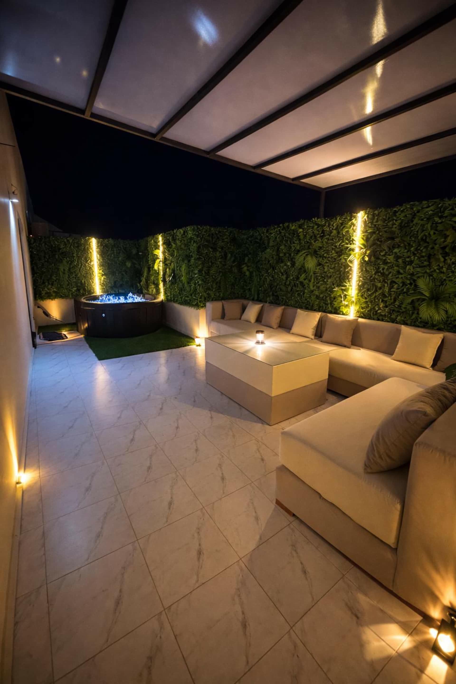Golden Studio's terrace at night with lounge and jacuzzi